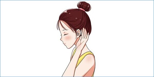 Girl adjusting her hearing aid for Getting Used To Hearing Aids. blog image