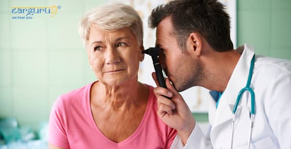 Doctor checking ears with otoscope. blog image